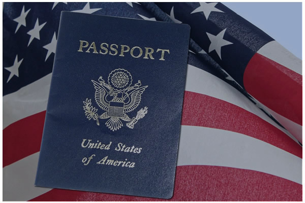Photo of a passport sitting on top of an American flag.