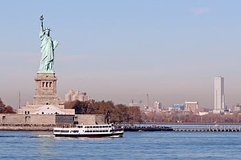 EB-5 Regional Center in New York. Photo of Statue of Liberty with New York City in the background.
